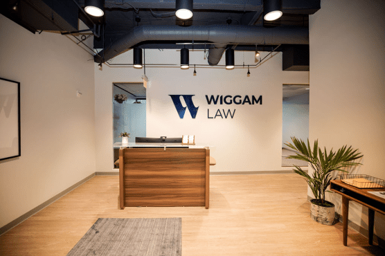 Office showing the front desk with a logo mounted to the back wall